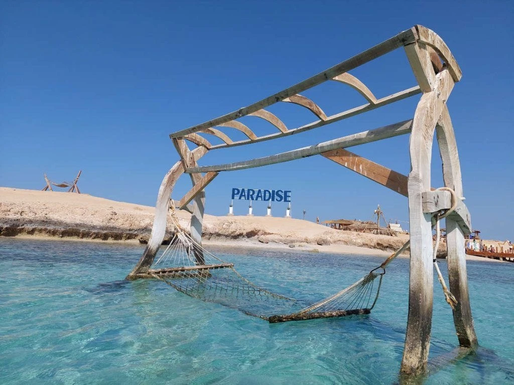 Visit Paradise Island from Hurghada on a private boat trip with snorkeling, beach relaxation, crystal-clear water, and beautiful Red Sea views.