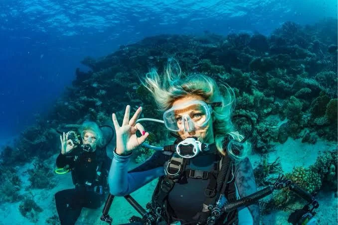 Experience scuba diving in Hurghada with professional guidance, diving equipment, colorful coral reefs, tropical fish, and beautiful Red Sea underwater views.